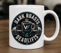 Dark Roasts & Deadlifts white ceramic mug with Vida Fit logo on wooden surface